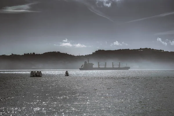 Seascape Silhouettes Huge Cargo Ship Barge Group Small Sport Sailboats — Stock Photo, Image