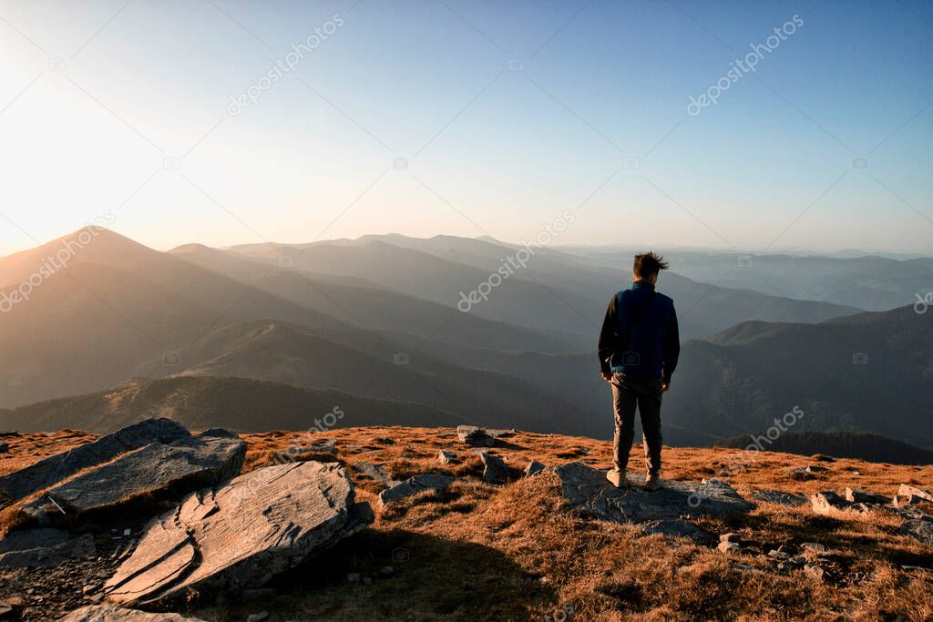 Man is feeling freedom in the top of the mountian