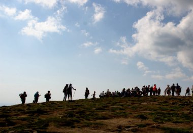 Şu anda yürüyen bir grup insanın siluetleri.