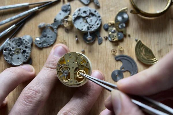 Watchmaker is repairing the mechanical watches in his workshop