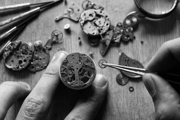 Watchmaker is repairing the mechanical watches in his workshop