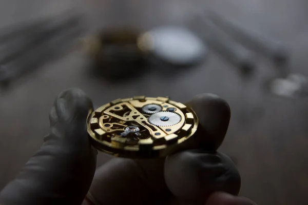 Watchmaker is repairing the mechanical watches in his workshop