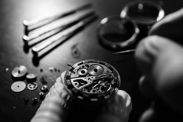 Watch maker is repairing a vintage automatic watch.