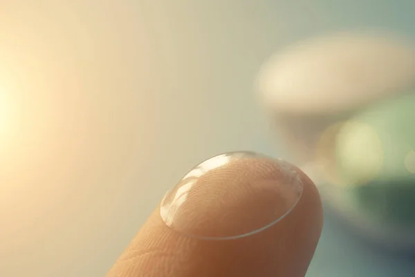 Contact lense on the finger, close up