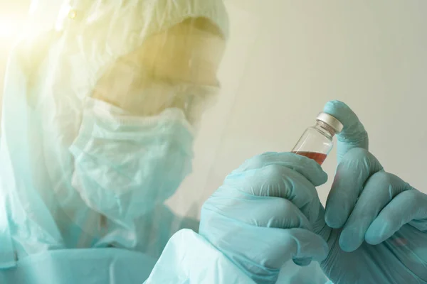 Aşıyı geliştiren doktor elinde bir ampul tutuyor.