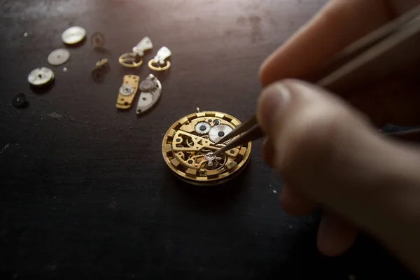 The watchmaker is repairing the mechanical watches, gear