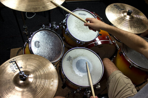 Guy plays the drums, close up