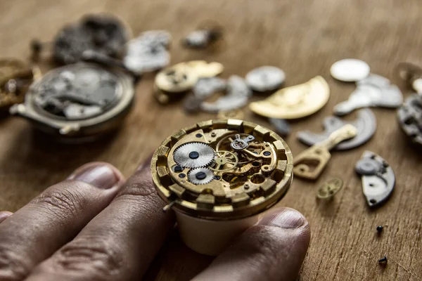 Watchmaker is repairing the wristwatch, mechanical watch, close up