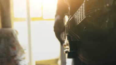 Adam evde gitar çalmayı seviyor.