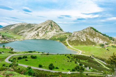 Enol Gölü 'nün yanındaki dolambaçlı yolun manzarası, Picos de europa Milli Parkı' nın çarpıcı zirveleri arasında yer almaktadır.