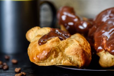 Ahşap arka planda kahve ve çikolata ekleriName