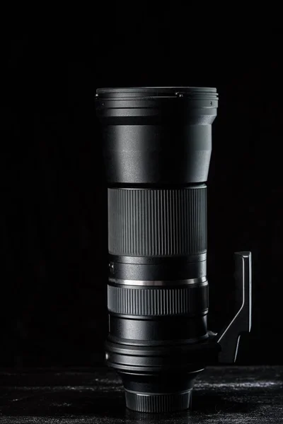 telephoto camera lens on a dark background