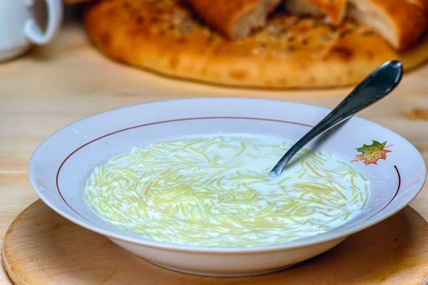 a plate of milk soup with vermicelli