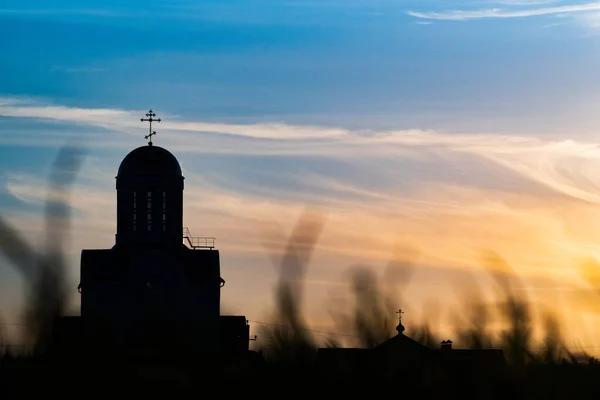 Church silhouette on a summer sunset background.