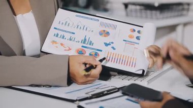 İş adamı masadaki dizüstü bilgisayarla finansal verileri analiz ediyor.