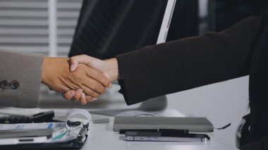 Modern ofiste görüştükten sonra iş adamları el sıkışıyor.