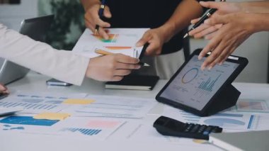 Hesap makinesindeki finansal verileri analiz eden ve ofiste dizüstü bilgisayarda çalışan iş adamlarının kapatılması