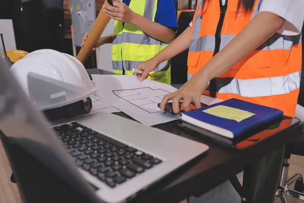 Endüstriyel mühendislerden oluşan bir ekip, fabrikadaki masada bulunan makine planlarını analiz ediyor. Fabrikada ya da üretim tesisinde çalışıyorum..