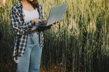 Smart farm. Farmer with tablet in the field. Agriculture, gardening or ecology concept. Harvesting. Agro business.