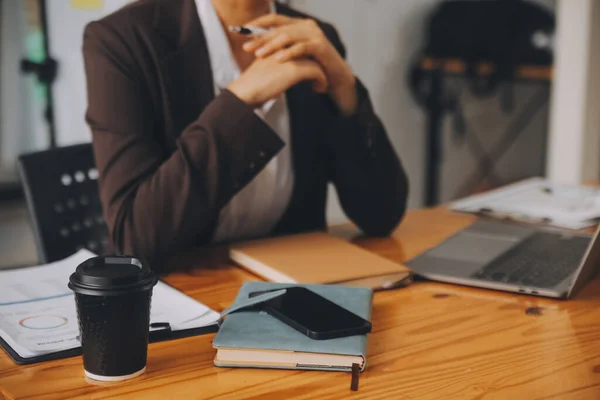 Asian businesswoman in formal suit in office happy and cheerful during using smartphone and working