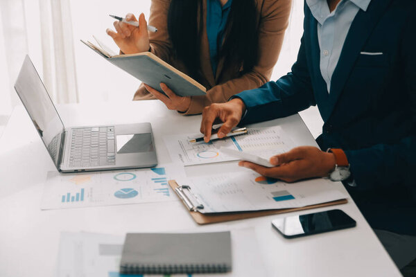 Business team working with new startup project plan and discussion information for financial strategy with laptop and digital tablet in a modern business lounge.