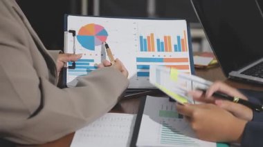 İş kadınları ofiste verileri tartışıyor ve analiz ediyorlar.