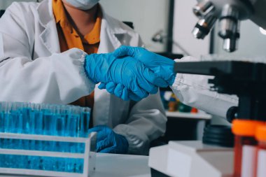 Araştırma ya da geliştirme için laboratuardaki insanlarla işbirliği, tablet ya da bilim. Tıbbi araştırma ve planlama için klinik deneyde bilim adamlarıyla buluşlar, teknolojiler ve mikroskop