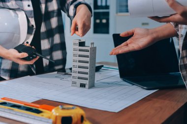 Modellik ve mühendislik araçları, inşaat konsepti ve çalışma sahasındaki proje ortağı ile çalışma planı toplantısı üzerine çalışan mühendis inşaat ve yapı kavramı.