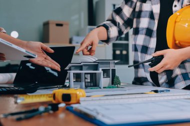 Modellik ve mühendislik araçları, inşaat konsepti ve çalışma sahasındaki proje ortağı ile çalışma planı toplantısı üzerine çalışan mühendis inşaat ve yapı kavramı.