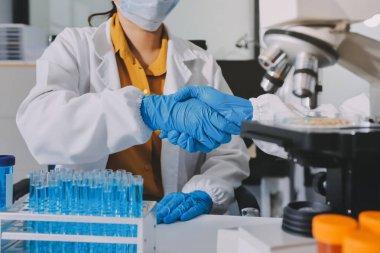 Araştırma ya da geliştirme için laboratuardaki insanlarla işbirliği, tablet ya da bilim. Tıbbi araştırma ve planlama için klinik deneyde bilim adamlarıyla buluşlar, teknolojiler ve mikroskop