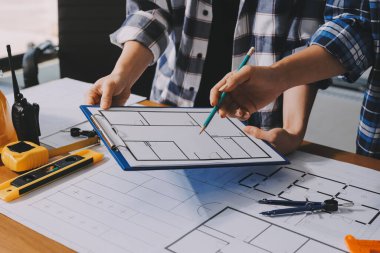 Modellik ve mühendislik araçları, inşaat konsepti ve çalışma sahasındaki proje ortağı ile çalışma planı toplantısı üzerine çalışan mühendis inşaat ve yapı kavramı.