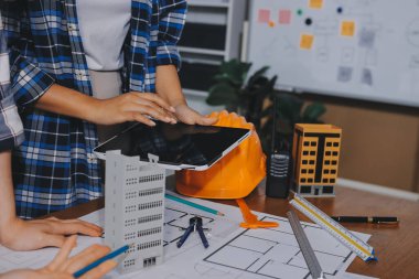 Modellik ve mühendislik araçları, inşaat konsepti ve çalışma sahasındaki proje ortağı ile çalışma planı toplantısı üzerine çalışan mühendis inşaat ve yapı kavramı.