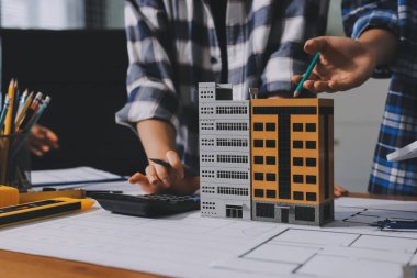 Modellik ve mühendislik araçları, inşaat konsepti ve çalışma sahasındaki proje ortağı ile çalışma planı toplantısı üzerine çalışan mühendis inşaat ve yapı kavramı.