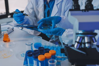 Araştırma ya da geliştirme için laboratuardaki insanlarla işbirliği, tablet ya da bilim. Tıbbi araştırma ve planlama için klinik deneyde bilim adamlarıyla buluşlar, teknolojiler ve mikroskop