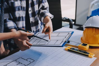 Modellik ve mühendislik araçları, inşaat konsepti ve çalışma sahasındaki proje ortağı ile çalışma planı toplantısı üzerine çalışan mühendis inşaat ve yapı kavramı.