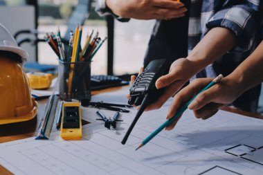 Modellik ve mühendislik araçları, inşaat konsepti ve çalışma sahasındaki proje ortağı ile çalışma planı toplantısı üzerine çalışan mühendis inşaat ve yapı kavramı.