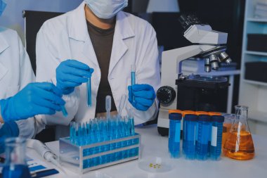 Araştırma ya da geliştirme için laboratuardaki insanlarla işbirliği, tablet ya da bilim. Tıbbi araştırma ve planlama için klinik deneyde bilim adamlarıyla buluşlar, teknolojiler ve mikroskop