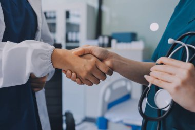 Medical team meeting analyzing blood test results in hospital laboratory. Doctors and scientists in lab coats are having a discussion about blood test result, holding test tubes and taking notes.