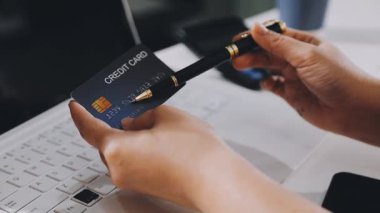 man paying with credit card using smartphone in restaurant