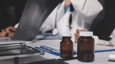 Doktor elinde ilaç şişesini tutuyor.