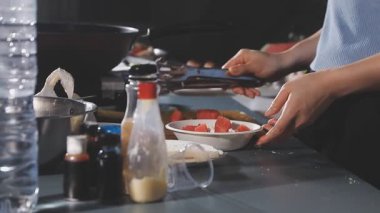 Mutfakta yemek pişirmek için yemek hazırlayan kadına yakın dur.