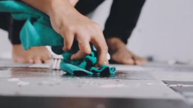 man in a white shirt is engaged in repair.