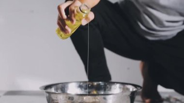 woman 's hand in white apron is preparing the cake for a birthday