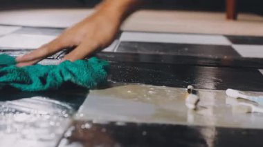 close up of woman hands painting a white paint