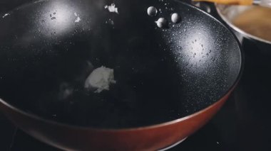 a closeup shot of a black and white frying pan in the kitchen
