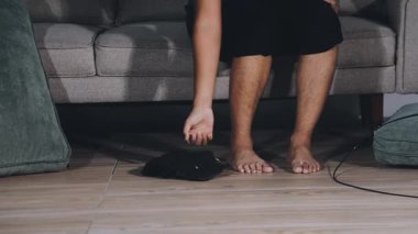 man using his laptop while sitting on the sofa at home