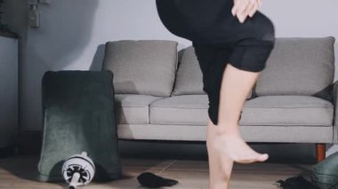 legs of young woman doing exercises in gym at home