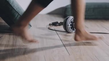 young woman doing stretching exercises on floor at home