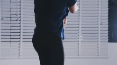 man stretching in the bedroom at night