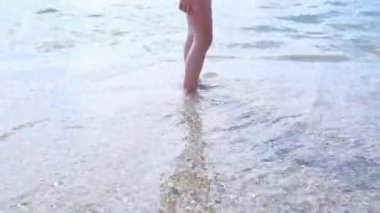 Mutlu yalınayak çocuk eğlenceli Plaj yürüyüş var. Kız deniz kenarında koşmak su havuzu tarafından sörf ve su sıçramalarına ile atlamak. Tropik adada çocuklarla tatil yaz